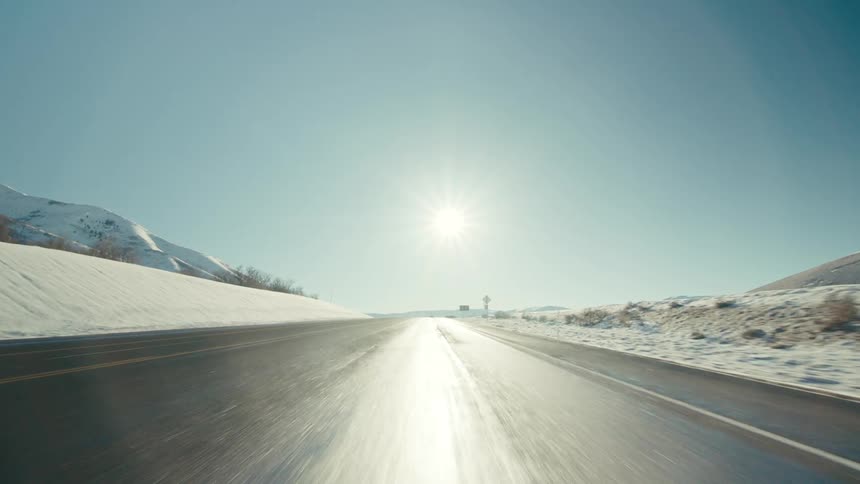 Vehicle driving on highway as the sun shining on tarmac