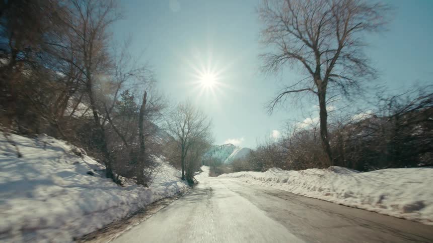 A road in a rural area is displayed during winter