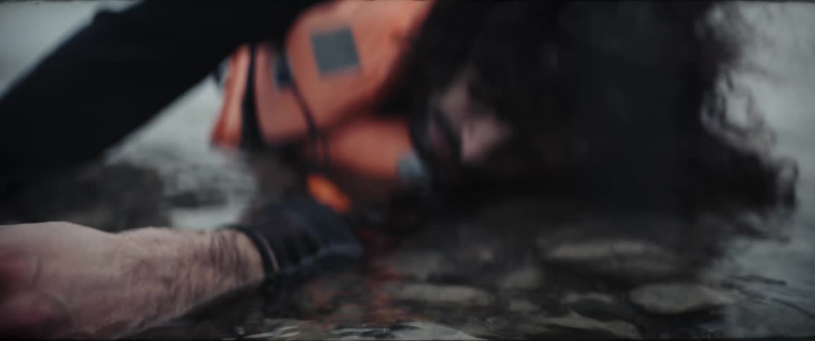 The view is of a man that is laying in the water outside