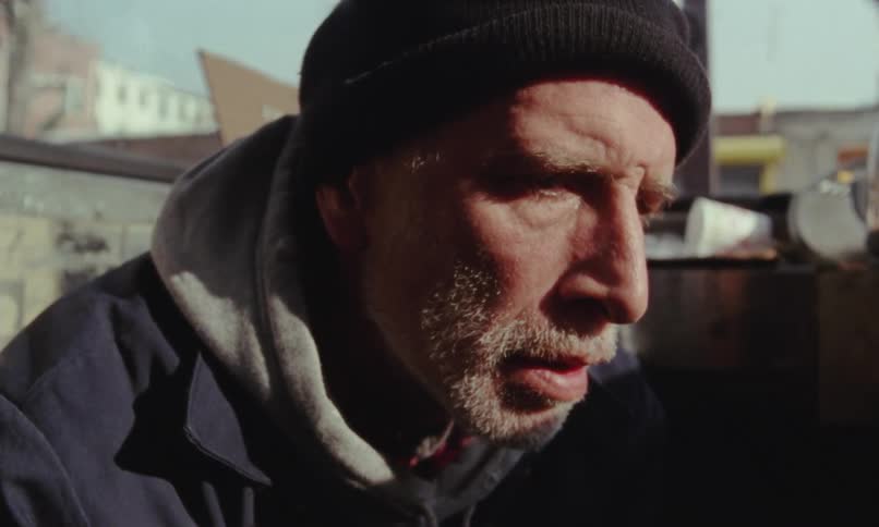 An older man is talking on the phone and he looks upset