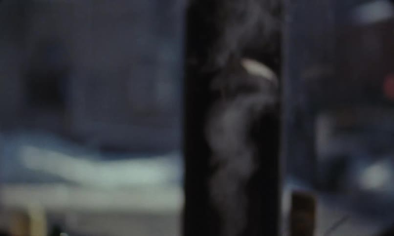 A stainless steel kettle with steam rolling out of it
