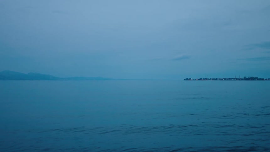 Aerial view of the ocean is displayed at dusk