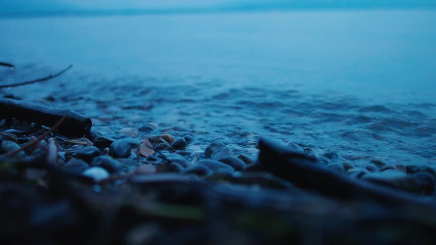 A close up of waves crashing against a rocky shore