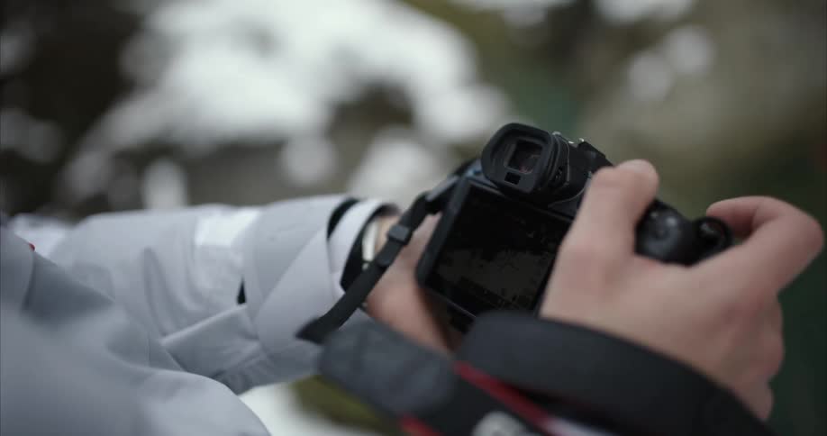 Close up view of a person holding a camera is displayed