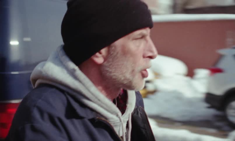 An angry man is outdoors and yelling at someone