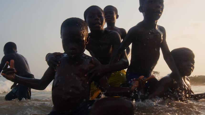 A group of children are swimming in the water