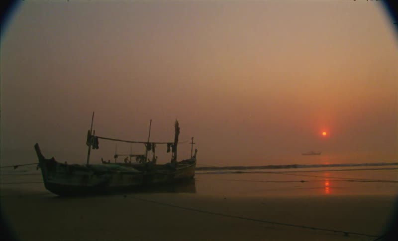 A boat is parked on the coast of the beach