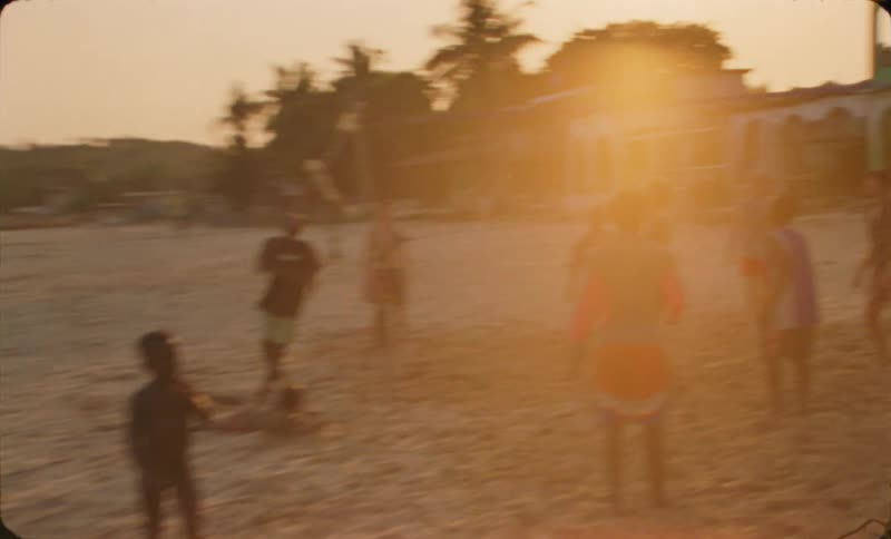A group of people are playing volleyball on the beach