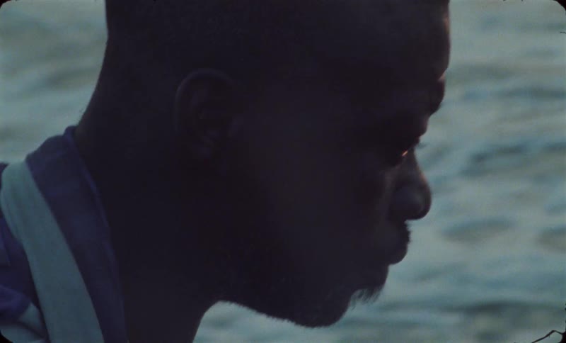 A man is sitting in a boat in the ocean water