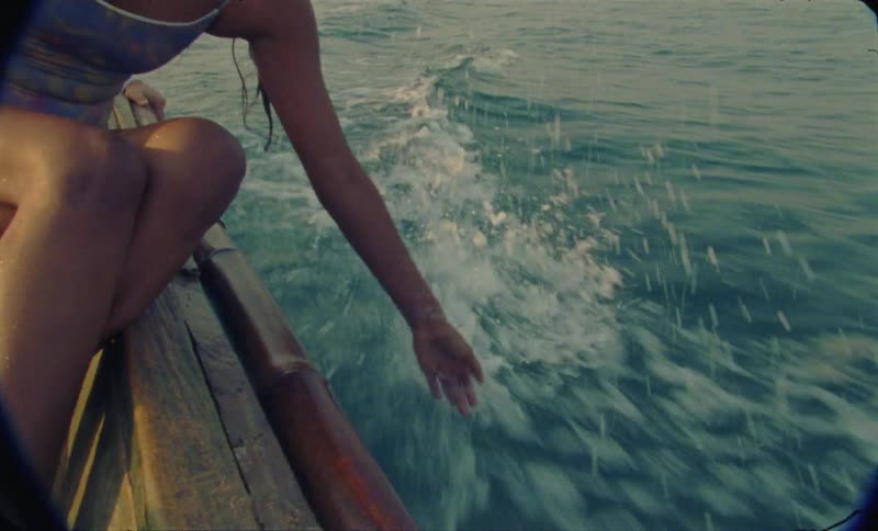 A female is riding on a boat in ocean water