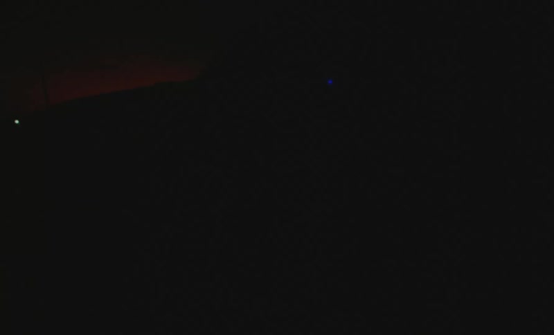 Silhouette of a taxi driving on a street at night caught on vintage film
