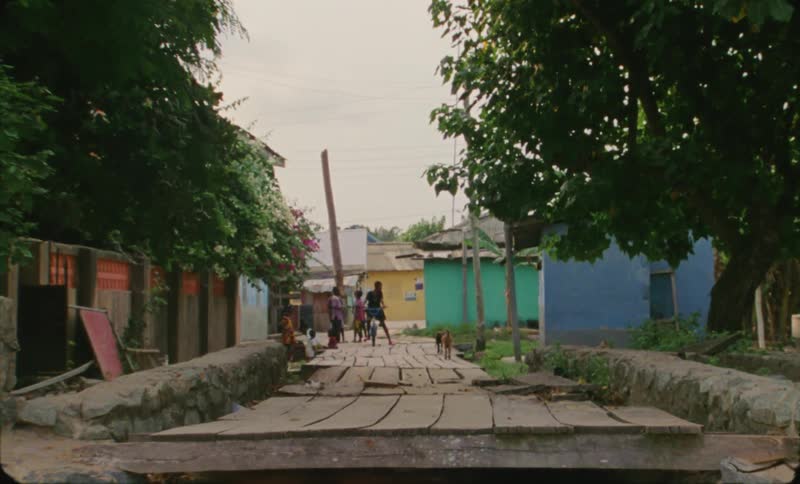 A shot of a wooden sidewalk with people walking on it
