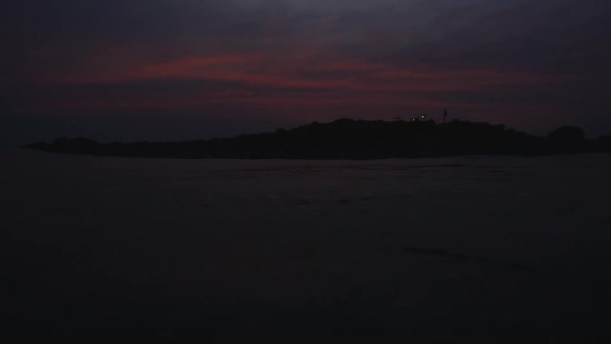 The view is of the ocean around night time
