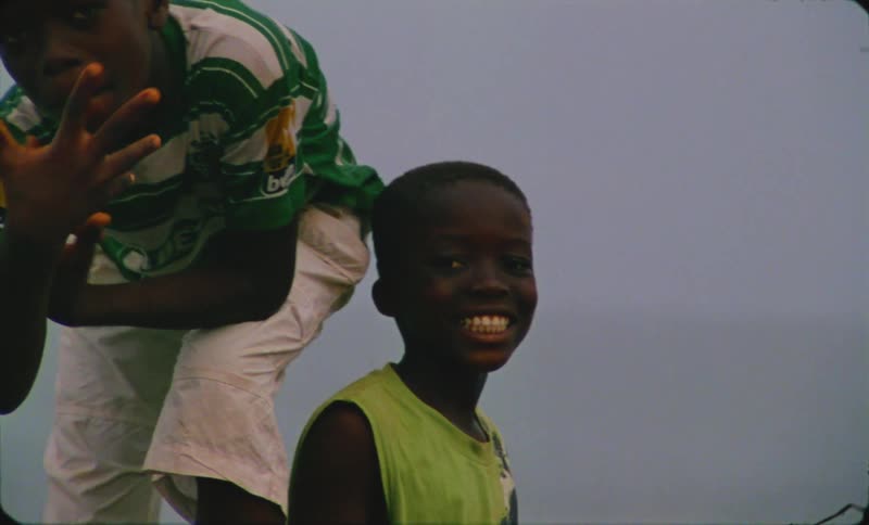Two male children are standing outside together