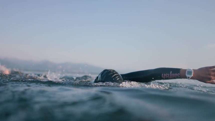 Slow motion view of a person swimming in water