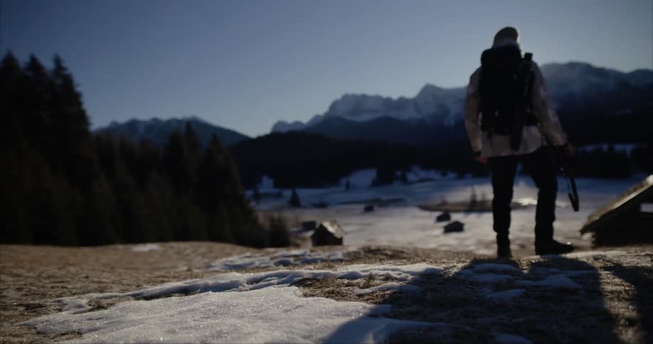A man is hiking in the wilderness and taking pictures