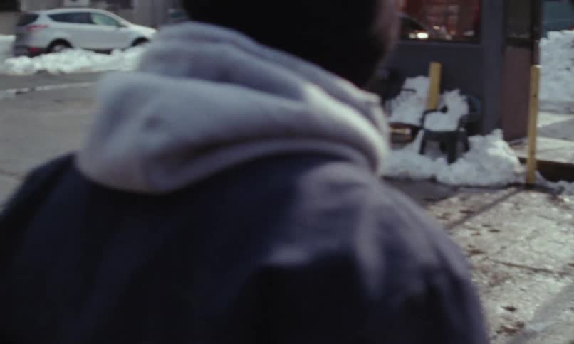 A man is walking through a suburban city
