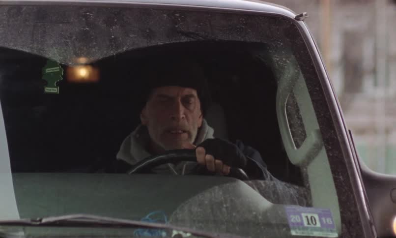 The view is of a man that is driving in his car