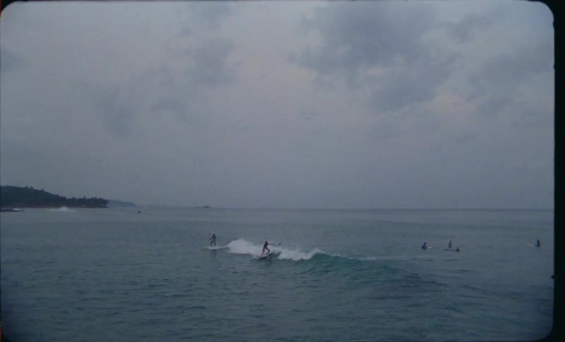 The view is of people surfing outdoors in the day time
