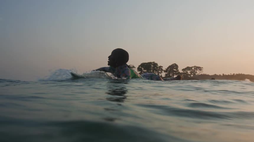 The view is of people surfing outdoors in the day time
