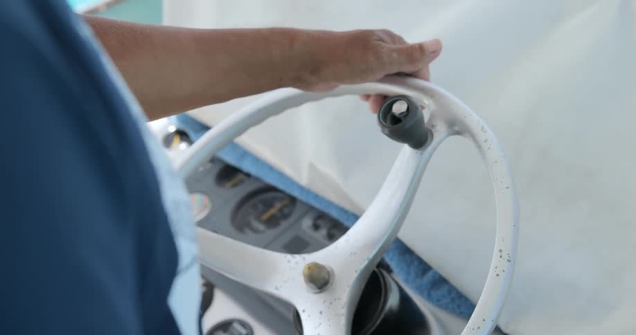 A man steers a boat
