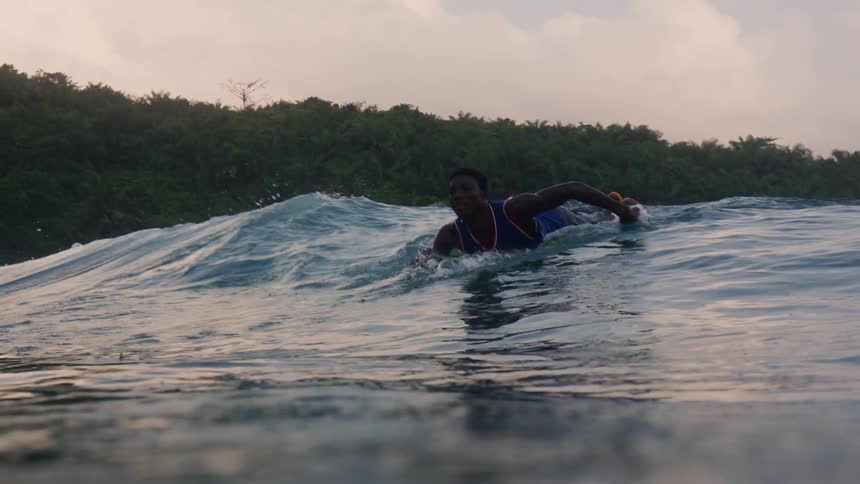 The view is of someone surfing outside in the day time
