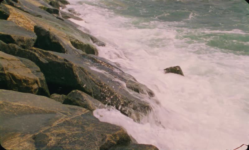 Ocean waves are crashing into the rocks