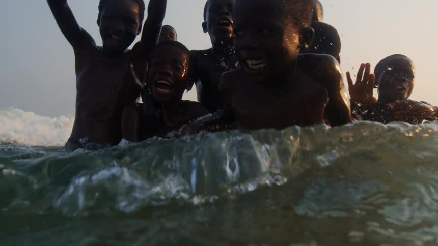 A group of children are swimming in the ocean