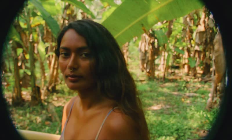 A young woman is posing for the camara in the forest area