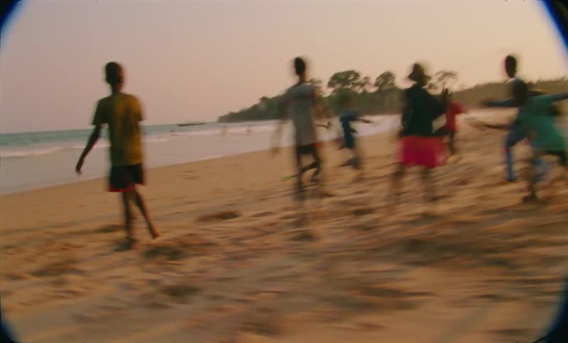 A group of kids are playing on the beach together