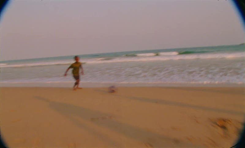 People playing soccer on the beach