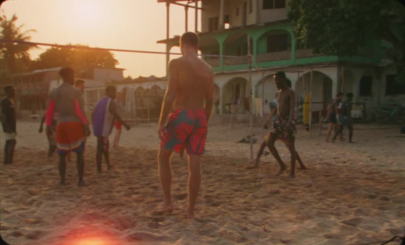 People are playing volleyball in the sand