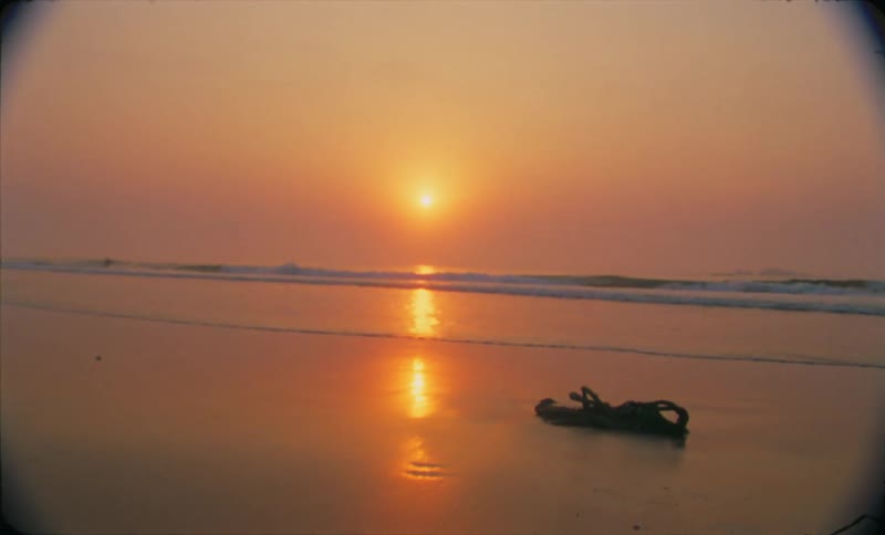 The sun is setting above the ocean water