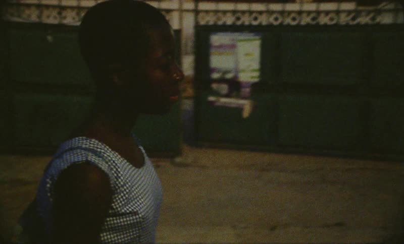 A female is walking through a neighborhood at night