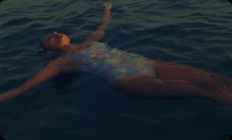 A female is swimming in a body of water