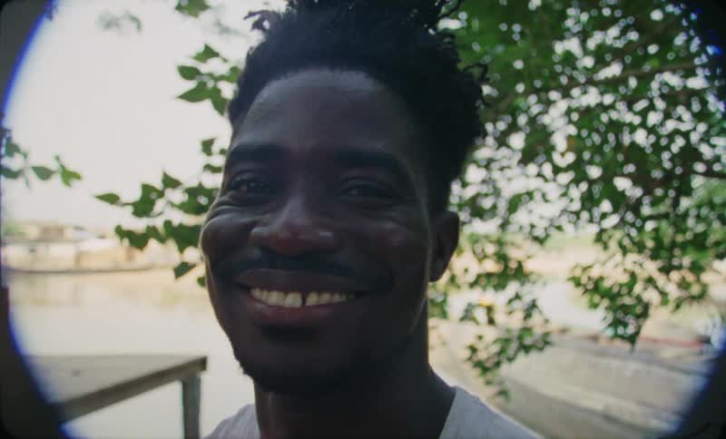 Man with white shirt smiles at camera