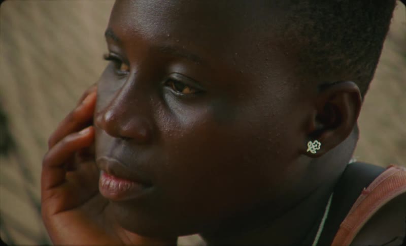 Close up of the face of a young woman of color caught on vintage film
