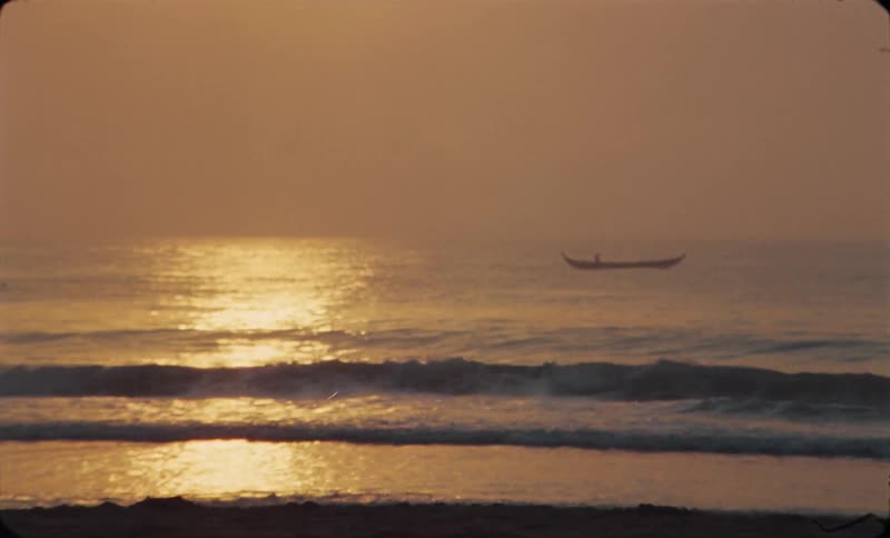A boat is driving on ocean water at dusk