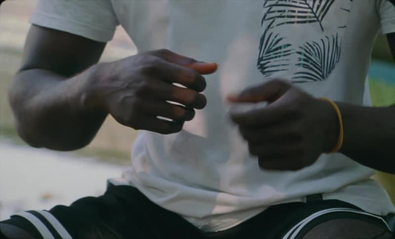 Close up of the hands of a man gesturing while talking caught on vintage film