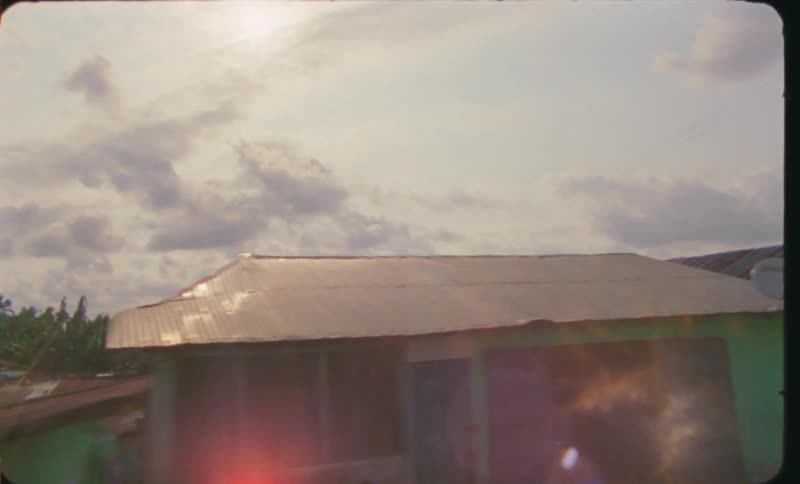 Houses on a third world country neighborhood at daytime caught on vintage film