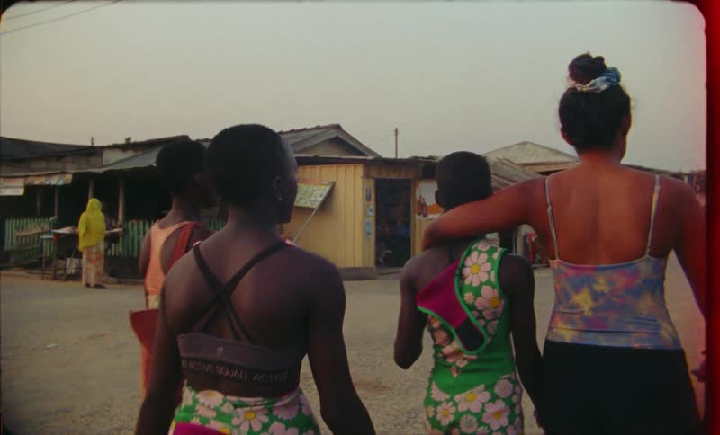 Group of friends walking on the streets of a third world country town at evening caught on vintage film