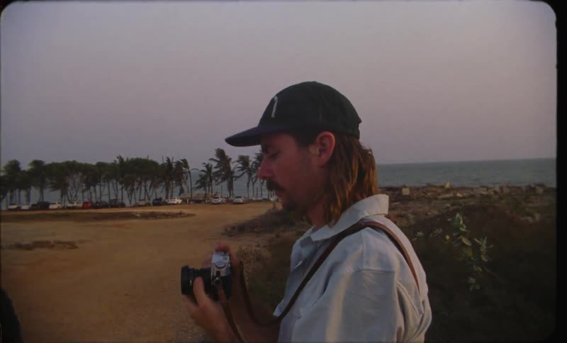 A man is taking pictures of people at the beach