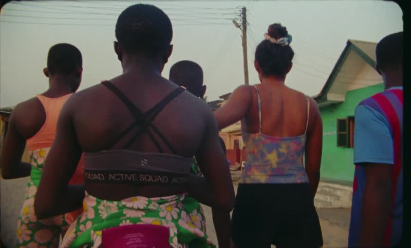 Group of friends walking on the streets of a third world country town at evening caught on vintage film