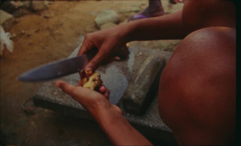 Someone preparing a spice with a knife