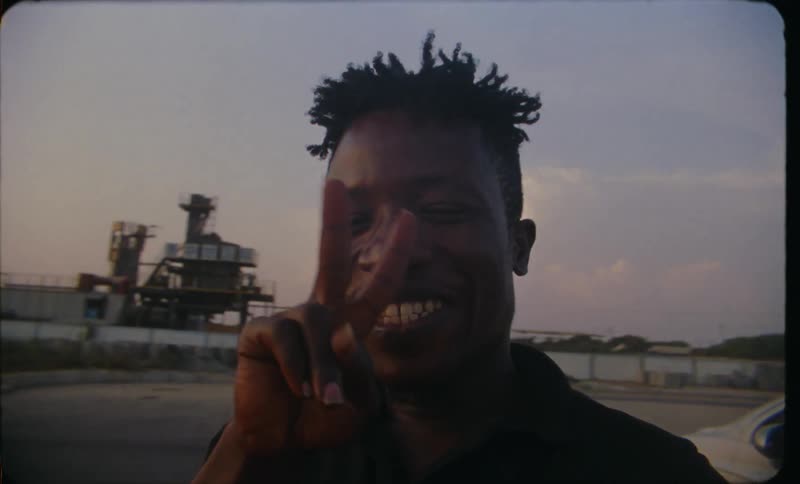Close up of the face of a young happy man smiling caught on vintage film