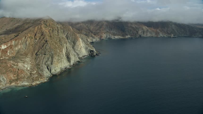 Drone footage captures the stunning beauty of steep coastal cliffs overlooking the empty sea off Santa Catalina Island California during summer