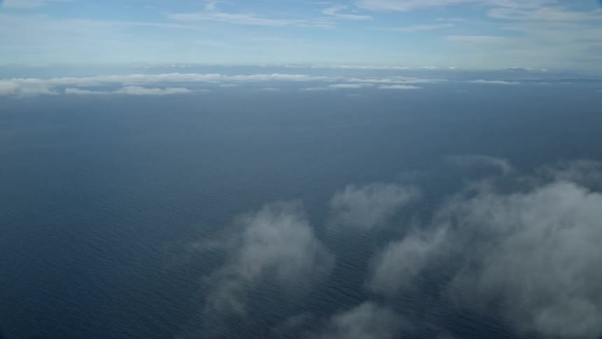 A breathtaking aerial shot of low level clouds over the Pacific Ocean off the coast of Southern California during a sunny summer day