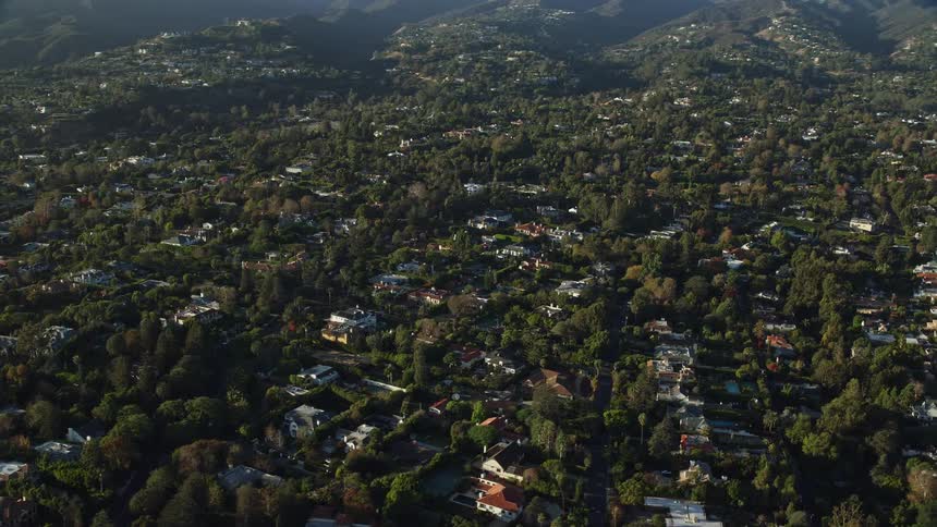 An epic aerial shot of upscale homes and mansions in Brentwood California on a sunny day