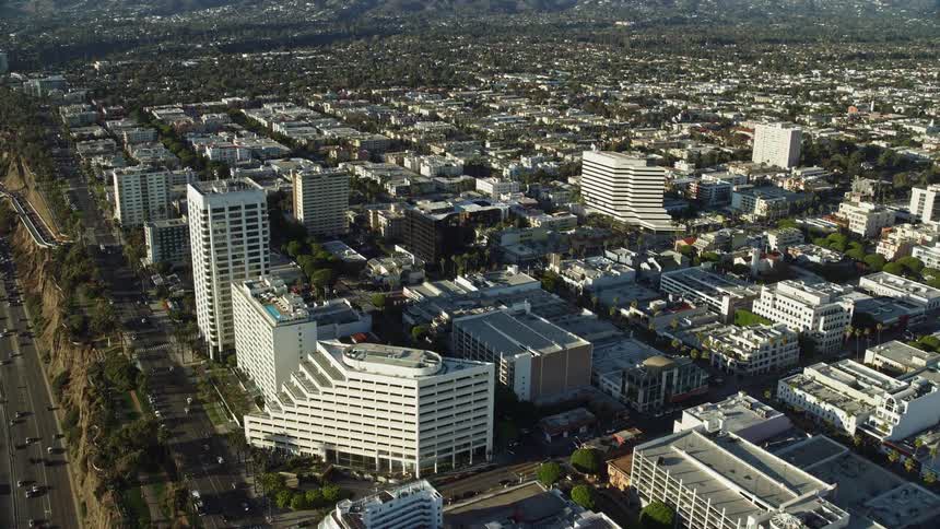 This is a aerial footage of office buildings by PCH and Ocean Avenue in Santa Monica California during the summer