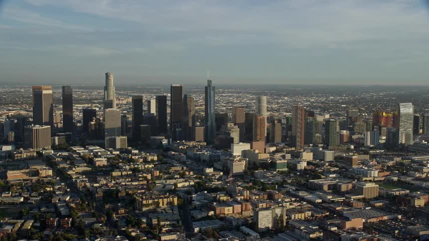 Flying past the Downtown Los Angeles skyscrapers during the day offering a wide angle view of Californias superstructures
